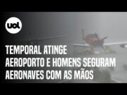 Temporal atinge aeroporto da Pampulha e homens seguram aeronaves com as mãos